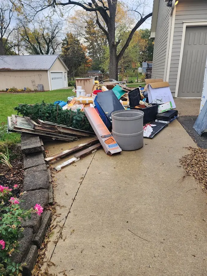 Dumpster being loaded with debris for 3 Yard Dumpster Rental in Huntsville